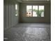 A bedroom is bright with a board and batten accent wall and light trim at 2577 Silas Peak Ln, Apex, NC 27523