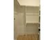 Walk-in closet with wooden rods and shelving for optimal storage solutions at 2577 Silas Peak Ln, Apex, NC 27523