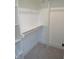 Walk-in closet with built-in shelving and wooden closet rod at 2577 Silas Peak Ln, Apex, NC 27523