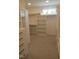 Walk-in closet with shelves and drawers at 2577 Silas Peak Ln, Apex, NC 27523