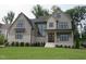 Attractive two-story home with manicured lawn, light exterior and dark window trim at 2577 Silas Peak Ln, Apex, NC 27523