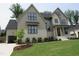 Charming two-story home with attached garage, fresh landscaping, and well-manicured lawn at 2577 Silas Peak Ln, Apex, NC 27523