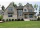 A beautiful two-story home with neutral colors, black window trim, and well-manicured front yard at 2577 Silas Peak Ln, Apex, NC 27523