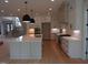 Bright, open kitchen features an island, stainless appliances, and white cabinetry at 2577 Silas Peak Ln, Apex, NC 27523
