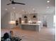 Spacious kitchen boasts a large center island with pendant lighting and white cabinetry at 2577 Silas Peak Ln, Apex, NC 27523