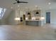 Open-concept kitchen with sleek white cabinets, modern island, and stainless steel appliances at 2577 Silas Peak Ln, Apex, NC 27523
