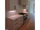 Modern kitchen features stainless steel range, white cabinetry, and marble backsplash at 2577 Silas Peak Ln, Apex, NC 27523