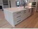 Kitchen island featuring stainless steel dishwasher, a sink, and ample drawer space at 2577 Silas Peak Ln, Apex, NC 27523