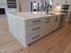 Kitchen island featuring stainless steel appliances, storage, and an undermount sink at 2577 Silas Peak Ln, Apex, NC 27523