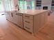 Kitchen island featuring stainless steel dishwasher, a sink, and ample drawer space at 2577 Silas Peak Ln, Apex, NC 27523