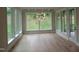 An open concept living room is illuminated by many large windows, filling it with natural light at 2577 Silas Peak Ln, Apex, NC 27523