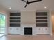 Bright living room boasts a fireplace and custom built-ins, creating a cozy and organized space at 2577 Silas Peak Ln, Apex, NC 27523