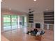 Bright living room features a fireplace with built-in shelving and sliding glass doors to the outside at 2577 Silas Peak Ln, Apex, NC 27523