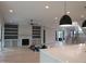 Open floor plan featuring a fireplace, built-in shelving, and access to an outdoor living space at 2577 Silas Peak Ln, Apex, NC 27523