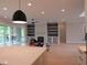 Spacious open floor plan with fireplace, built-in shelving, and access to a screened porch at 2577 Silas Peak Ln, Apex, NC 27523