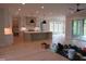 Open-concept living space features an island kitchen and an outdoor patio area at 2577 Silas Peak Ln, Apex, NC 27523
