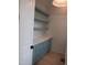 Charming pantry features custom shaker cabinets, white countertops, and open shelving for storage at 2577 Silas Peak Ln, Apex, NC 27523