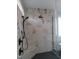New bathroom featuring a large shower with a bench and marble tile at 2577 Silas Peak Ln, Apex, NC 27523