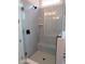 Modern shower features gray tile, a built-in bench, and glass surround at 2577 Silas Peak Ln, Apex, NC 27523