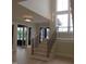Staircase with hardwood stairs, black metal railings, and large bright window at 2577 Silas Peak Ln, Apex, NC 27523