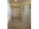 This walk-in closet features built-in shelving, drawers, and ample hanging space for organized storage at 2577 Silas Peak Ln, Apex, NC 27523