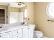 Bright bathroom features double vanity with white cabinets and an oval window at 2617 Charenson Pl, Raleigh, NC 27614