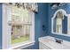 Charming bathroom with blue walls, white vanity and a window bringing in natural light at 2617 Charenson Pl, Raleigh, NC 27614