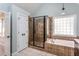 Well-lit Primary bathroom featuring a soaking tub, tiled walk-in shower, and a linen closet at 2617 Charenson Pl, Raleigh, NC 27614