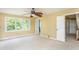 Spacious bedroom with neutral carpet, ceiling fan, and natural light from the windows at 2617 Charenson Pl, Raleigh, NC 27614