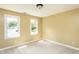 Bedroom featuring neutral carpet and two windows bringing in natural light at 2617 Charenson Pl, Raleigh, NC 27614