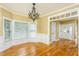 Elegant dining room featuring hardwood floors, large windows, and a stylish chandelier at 2617 Charenson Pl, Raleigh, NC 27614