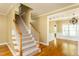 Bright foyer with hardwood floors and staircase leading to upper level, creating a grand entrance at 2617 Charenson Pl, Raleigh, NC 27614