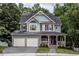 Charming two-story house with a well-manicured front yard and two car garage at 2617 Charenson Pl, Raleigh, NC 27614