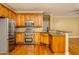 Open kitchen featuring stainless steel appliances, granite countertops, and hardwood flooring at 2617 Charenson Pl, Raleigh, NC 27614