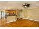 Open floor plan with living room next to updated kitchen with stainless steel appliances and hardwood floors at 2617 Charenson Pl, Raleigh, NC 27614