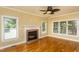 Bright living room with a brick fireplace and hardwood floors and lots of natural light from the windows at 2617 Charenson Pl, Raleigh, NC 27614