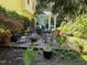 Backyard showing the sunroom and deck with outdoor seating in a landscaped garden at 2645 Ridgewell Ct, Raleigh, NC 27613