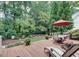 Relaxing backyard with a patio, outdoor seating, and mature trees at 2645 Ridgewell Ct, Raleigh, NC 27613