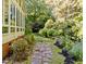 Stone pathway winding through a lush backyard garden, showcasing the home's serene outdoor space at 2645 Ridgewell Ct, Raleigh, NC 27613