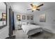 A simplistic bedroom with neutral colors and a ceiling fan, giving off a calming atmosphere at 2645 Ridgewell Ct, Raleigh, NC 27613