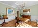 Charming dining room with hardwood floors, modern lighting, and decorative wainscoting at 2645 Ridgewell Ct, Raleigh, NC 27613