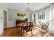 Elegant dining room featuring a bay window, chandelier, hardwood floors, and decorative molding at 2645 Ridgewell Ct, Raleigh, NC 27613