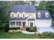 Charming two-story home with a manicured lawn, brick walkway, and attached two car garage at 2645 Ridgewell Ct, Raleigh, NC 27613