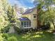 Back exterior showcasing sunroom with a stone walkway, beautiful landscaping, and the home's exterior at 2645 Ridgewell Ct, Raleigh, NC 27613