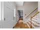 Welcoming foyer with hardwood floors, a staircase, and an inviting view into the adjacent room, creating a warm entrance at 2645 Ridgewell Ct, Raleigh, NC 27613