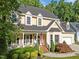 Charming front exterior with an inviting front porch, manicured landscaping, and an American flag display at 2645 Ridgewell Ct, Raleigh, NC 27613