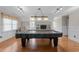 Entertaining game room with pool table, hardwood floors, and plenty of natural light at 2645 Ridgewell Ct, Raleigh, NC 27613