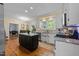 Bright kitchen featuring granite countertops, white cabinetry, stainless steel appliances, and hardwood floors at 2645 Ridgewell Ct, Raleigh, NC 27613