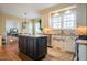 Bright eat-in kitchen featuring white cabinets, a gray island, and stainless steel appliances at 2645 Ridgewell Ct, Raleigh, NC 27613