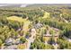 Aerial view of the neighborhood clubhouse, offering golf course access and surrounded by lush greenery and parking at 268 The Preserve Trl, Chapel Hill, NC 27517